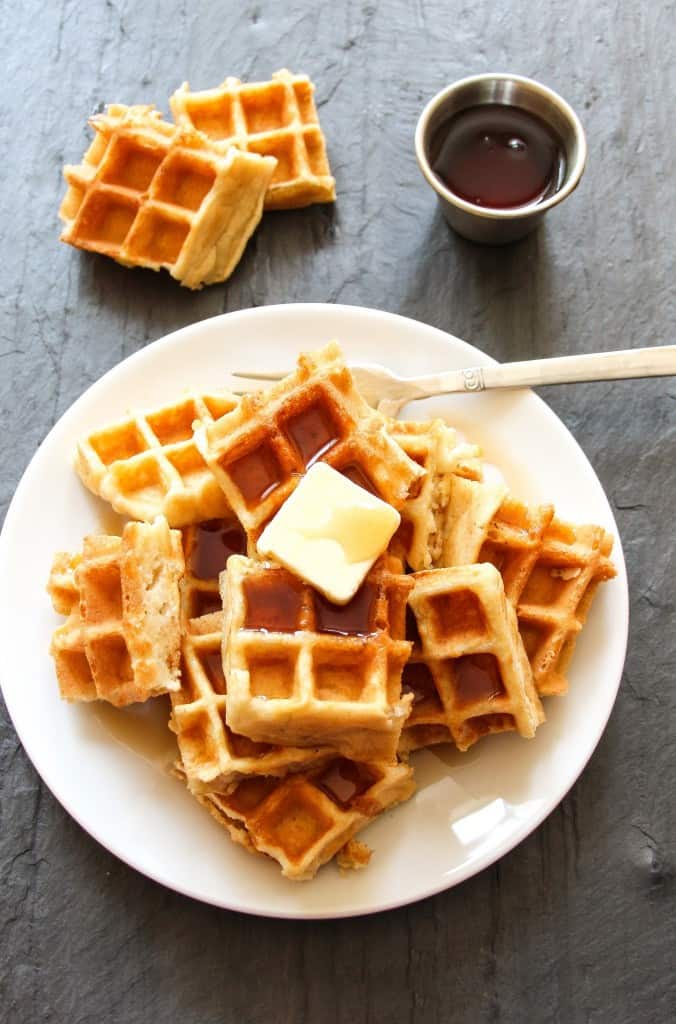 Overhead shot of Gluten Free Belgium Waffles topped with maple syrup and butter