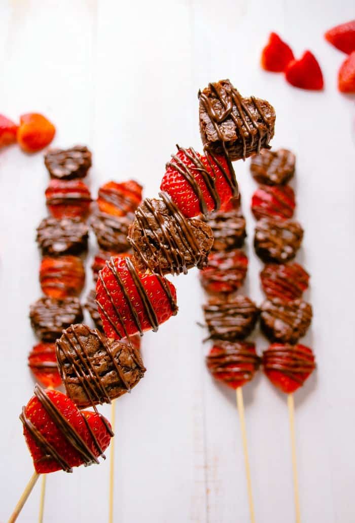 Strawberry brownie kebabs alternated on a stick and drizzled with chocolate