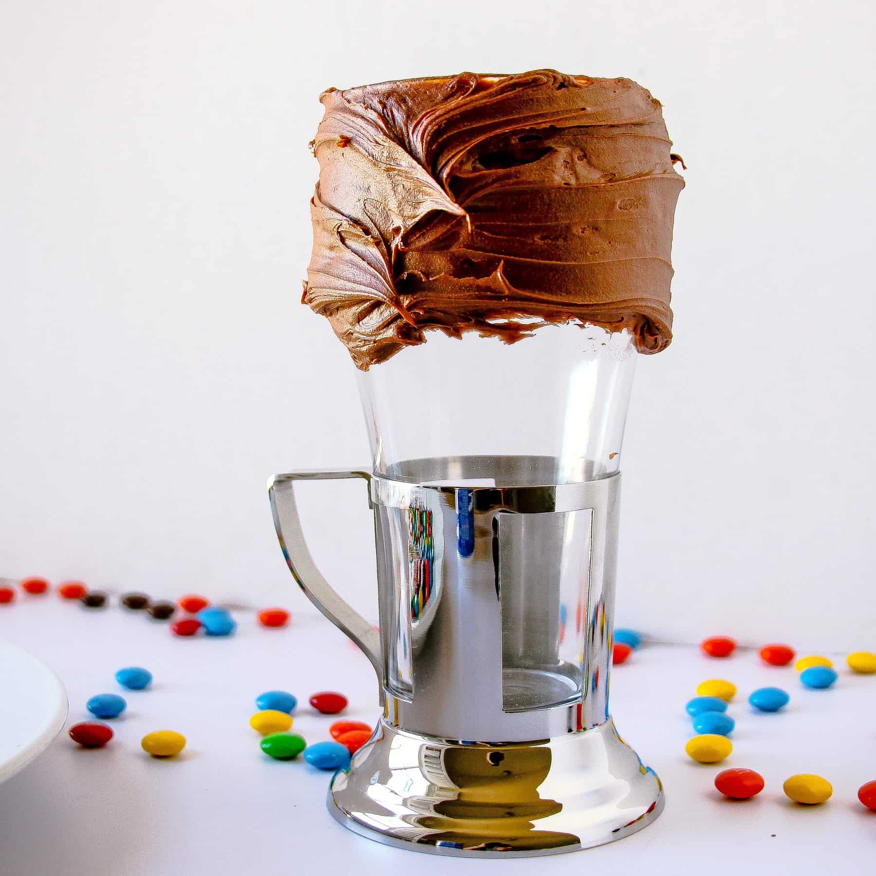 Chocolate frosting on the rim of a milkshake glass