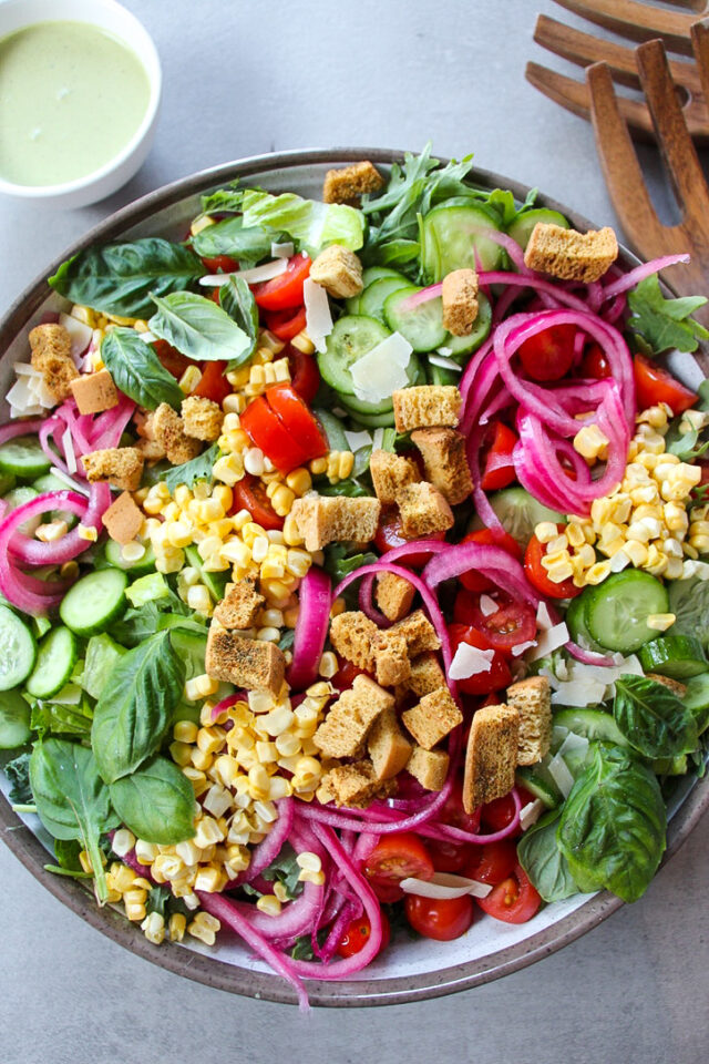 Fresh cucumbers, cherry tomatoes, raw corn, pickled onions, and pesto vinaigrette.