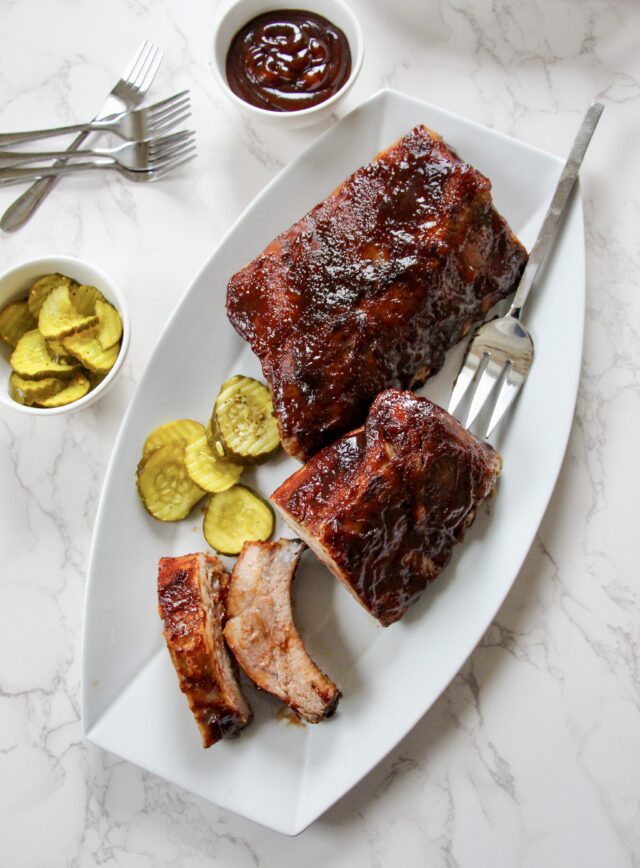 Easy Slow Cooker Ribs Recipe plated with bread and butter pickles