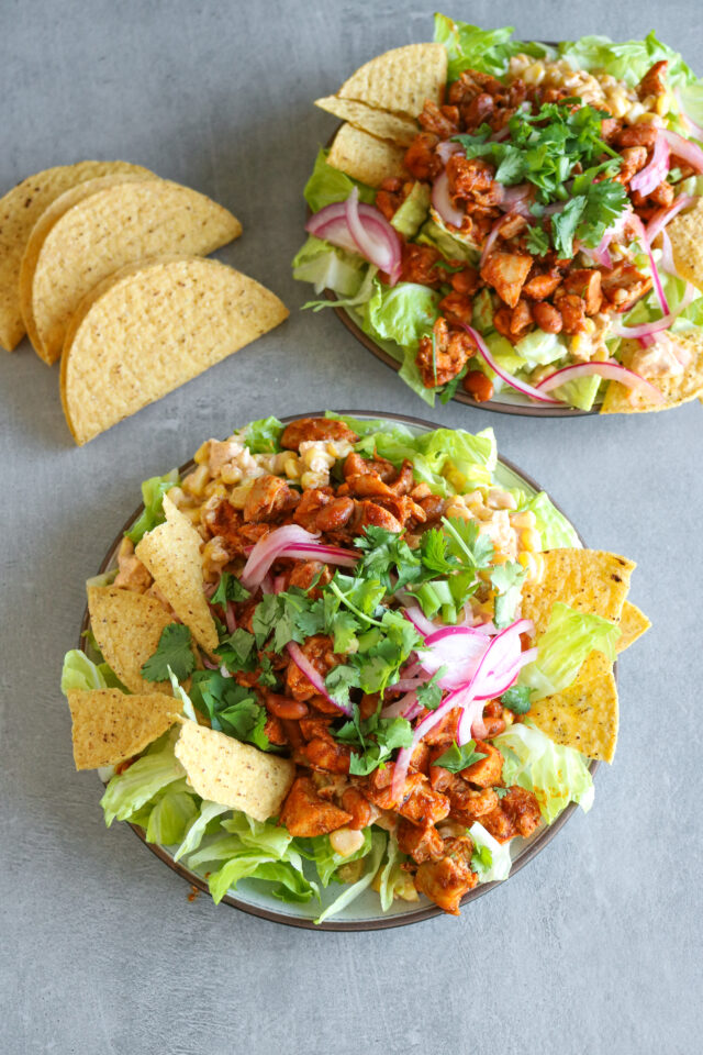 Chicken taco salads with pickled onions and taco sauce