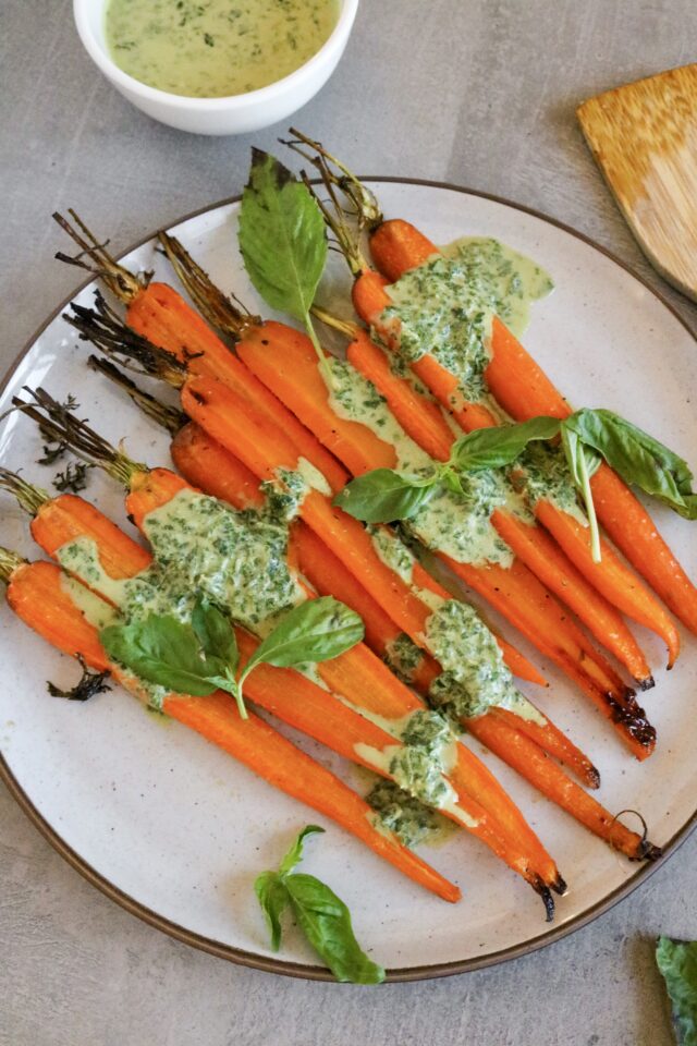 Glazed carrots with basil goat cheese sauce and fresh basil on top