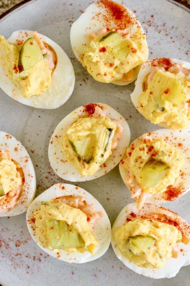 Pimento cheese deviled eggs with smoked paprika on top.