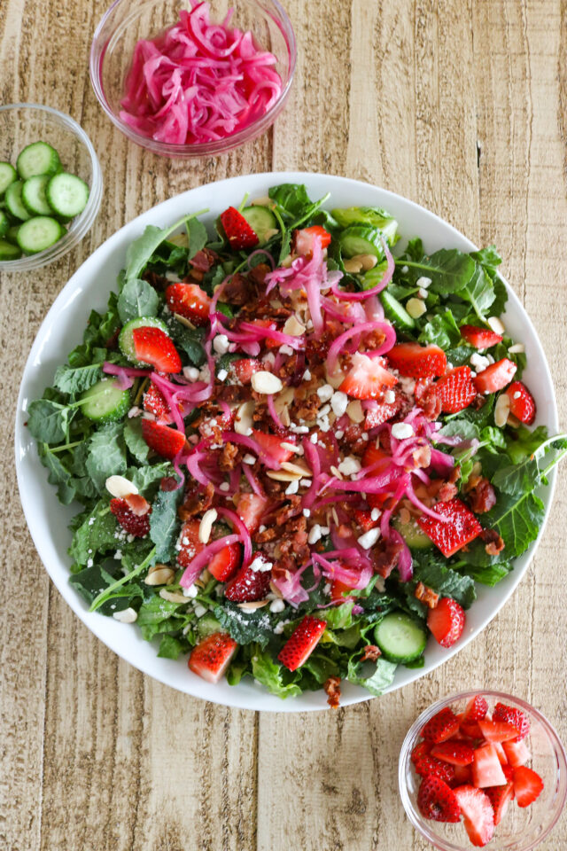 Overhead shot of strawberry goat cheese salad in a salad bowl