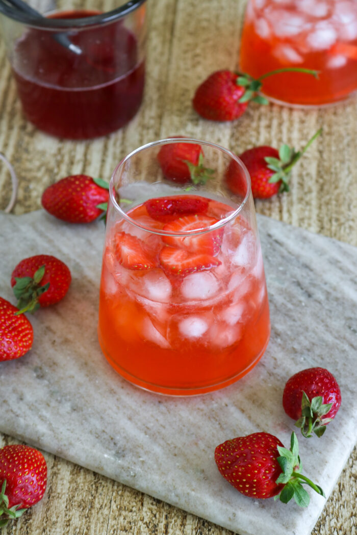 Far off shot of strawberry syrup cocktail over ice