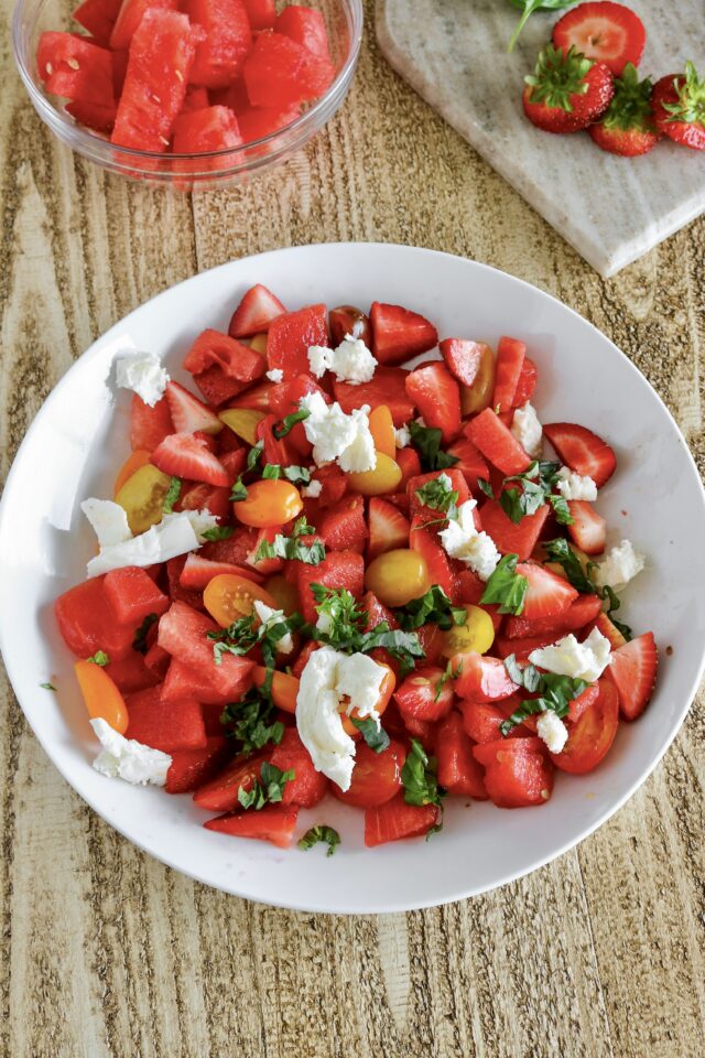 Overhead photo of the watermelon strawberry caprese salad in a bowl