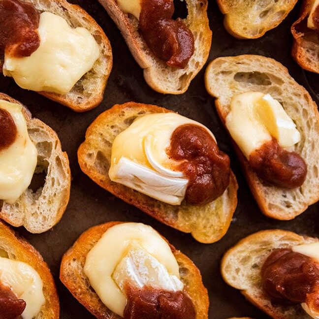 An overhead shot of a plate full of apple butter crostinis