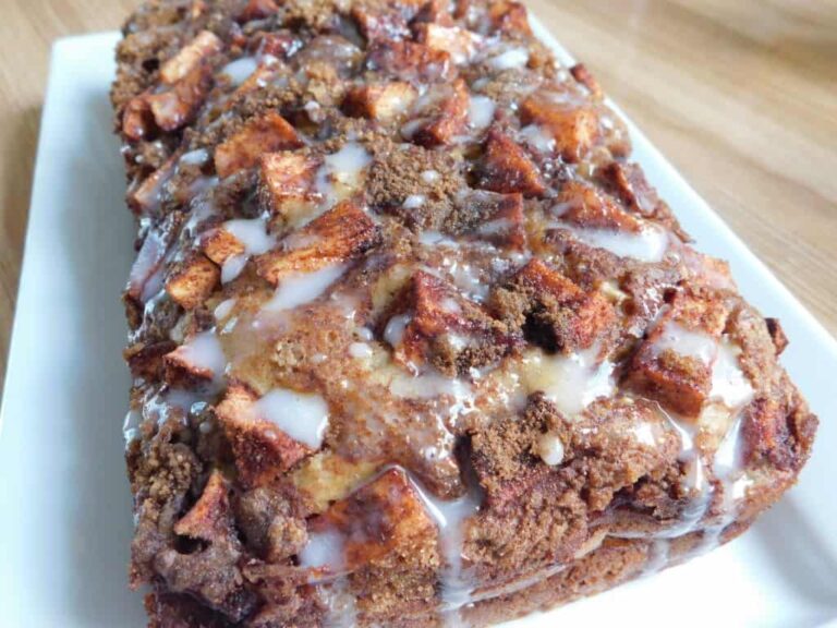 Side shot of finished apple fritter quick bread with a glaze to finish