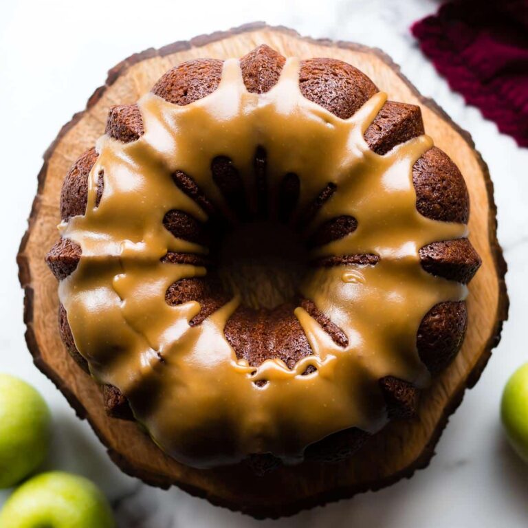 An overhead shot of a glazed apple bundt cake with the brown sugar glaze pour over top and let drip down the sides