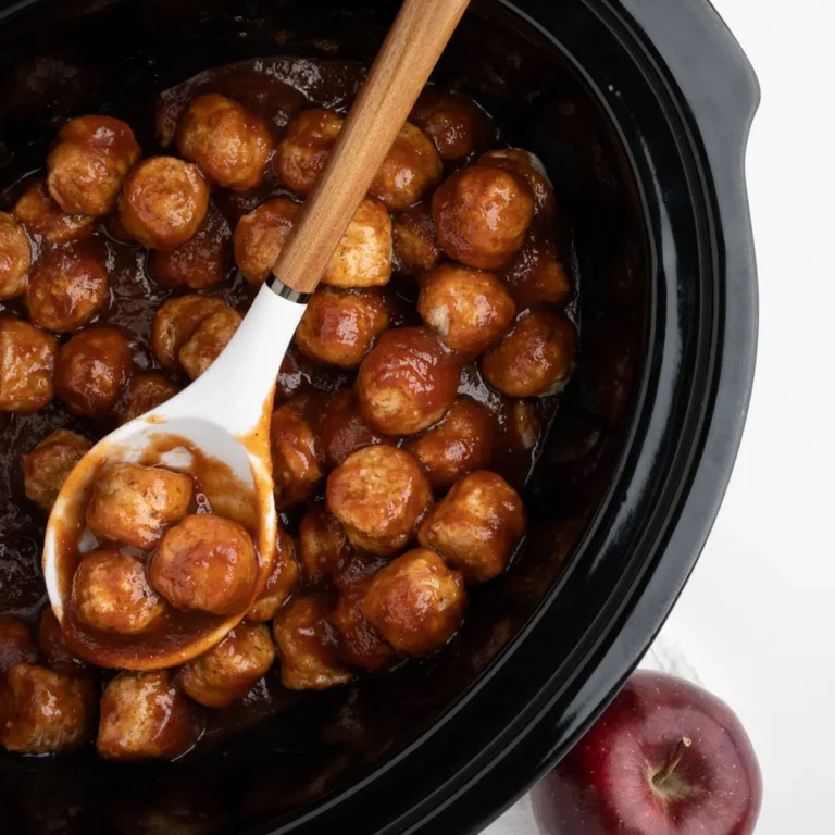 The full crockpot of finished apple butter meatballs