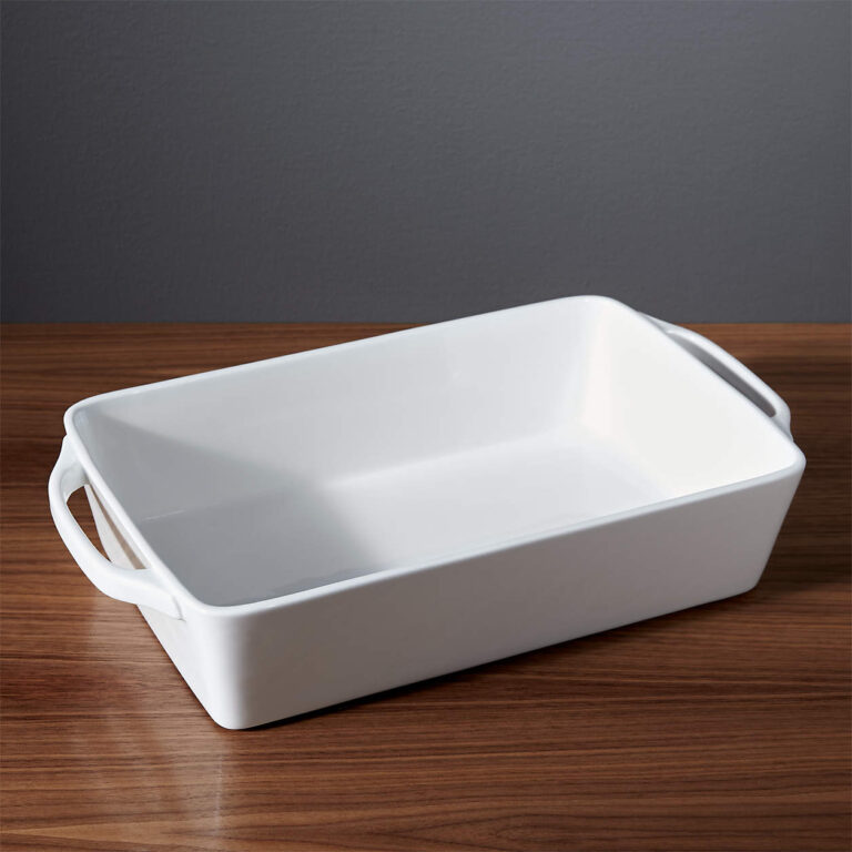 A white serving dish with handles on the ends