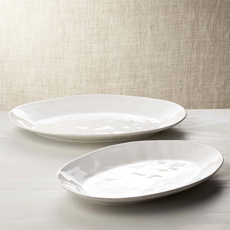 Two large white serving platters on a table