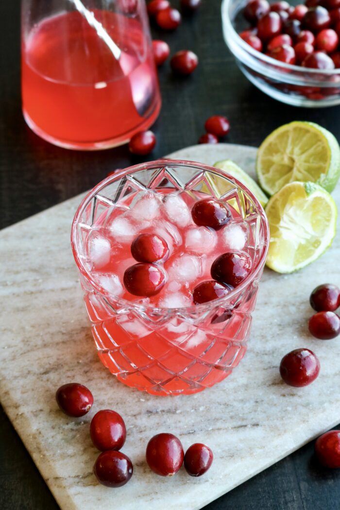 Christmas Margarita with fresh cranberries and a lime wedge