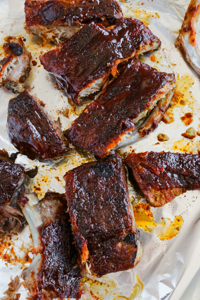 Easy Slow Cooker Ribs Recipe cut into pieces on a baking sheet