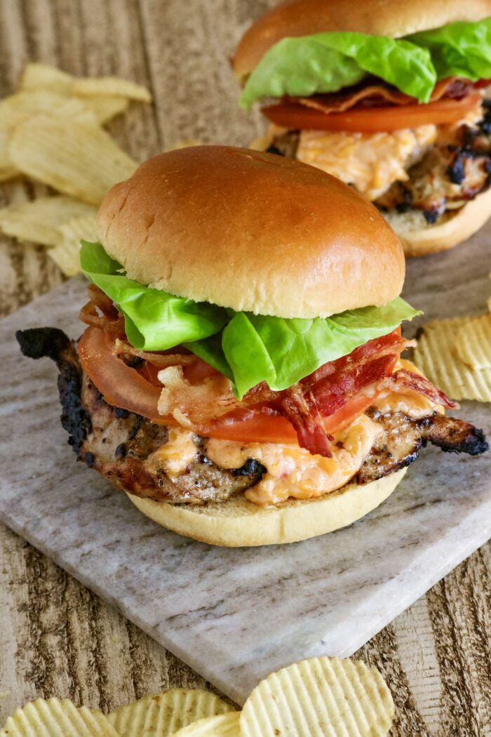 Club Sandwich with Chicken on a platter with chips